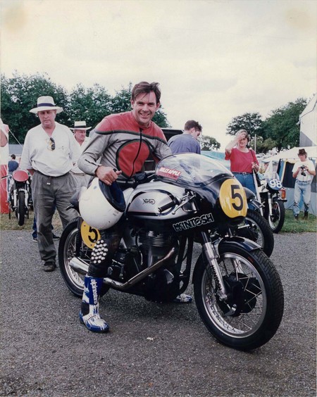 John Britten on Billy Apple’s 500 Manx Norton at the 1995 annual NZCMRR (New Zealand Classic Motorcycle Racing Register) meeting, Pukekohe Park Raceway, 28 January 1995. Apple is standing behind the bike on the left. Photo: Steve Green