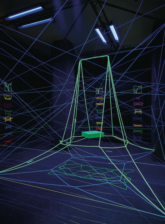 Maureen Lander String Games 1998. Rope, nylon fishing wire, neon painted string, cardboard, paper, linen, glue, laser discs, CDs, photographic prints, white and ultra-violet light. Collection of the Museum of New Zealand Te Papa Tongarewa, commissioned 1998