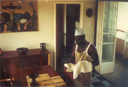 R.N. O'Reilly Dining room with Busari the cook, Ibadan, Nigeria c.1964-6. Photograph. Courtesy of the R.N. O'Reilly Estate.