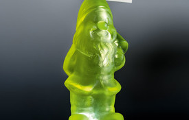 Gregor Kregar Small Uranium Gnome with Mushroom 1/3 2016. Cast glass (uranium glass) on LED light bo. Reproduced courtesy of the artist. Photo: John Collie