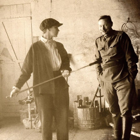 Natalia Goncharova and Mikhail Larionov on the background scenery for the opera-ballet The Golden Cockerel in the workshops of the Bolshoi Theatre, Moscow, 1913. Anonymous photographer from the Russian Empire (before 1917). Public domain, via Wikimedia Commons