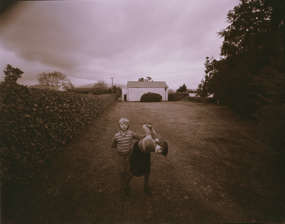 Kamala and Charlotte in the grounds of the Lodge, Tawera, Oxford, 1981, by Laurence Aberhart