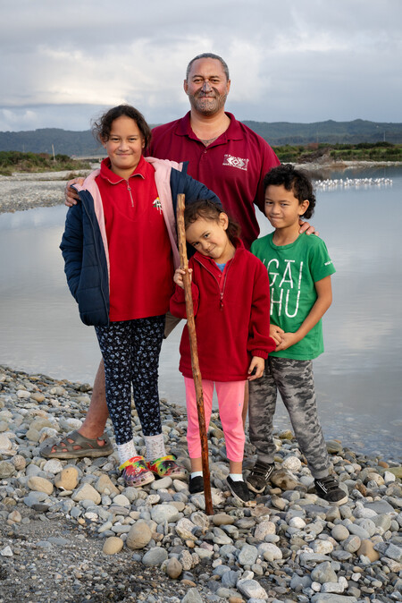 Anne Noble Te Rua Mason (Kāti Waewae - Poutini Kāi Tahu, Waikato Tainui - Ngā Tokotoru, Ngaruahine – Aotearoa, Te Arawa - Ngāti Whakaue,Tūhoe - Ruatāhuna Kākahu Mauku), with his tamariki, Arahura River 2023. Digital print, pigment on paper. Collection of Te Rūnanga o Ngāi Tahu