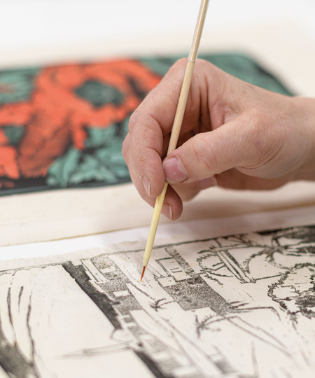 Works on paper conservator Eliza Penrose working on prints for the Ink on Paper exhibition, 2022