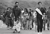 1975 Māori Land March, Dave Ruru wheels his daughter Tania along the Wellington motorway south of Porirua, Monday, 13th October, 1975