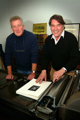 Printer Tara McLeod and Peter Simpson checking proofs for Leo Bensemann's book of wood-engravings, 2004.